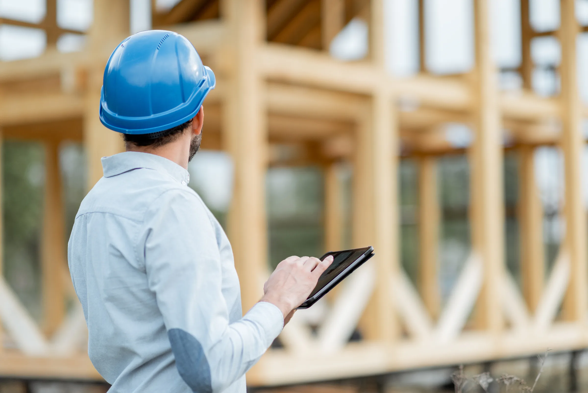 A contractor reviewing plans with homeowners